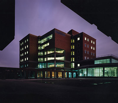 An exterior view of the Computer Studies Building at night.