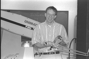 Randal Nelson with PUMA robot and MIT hand.