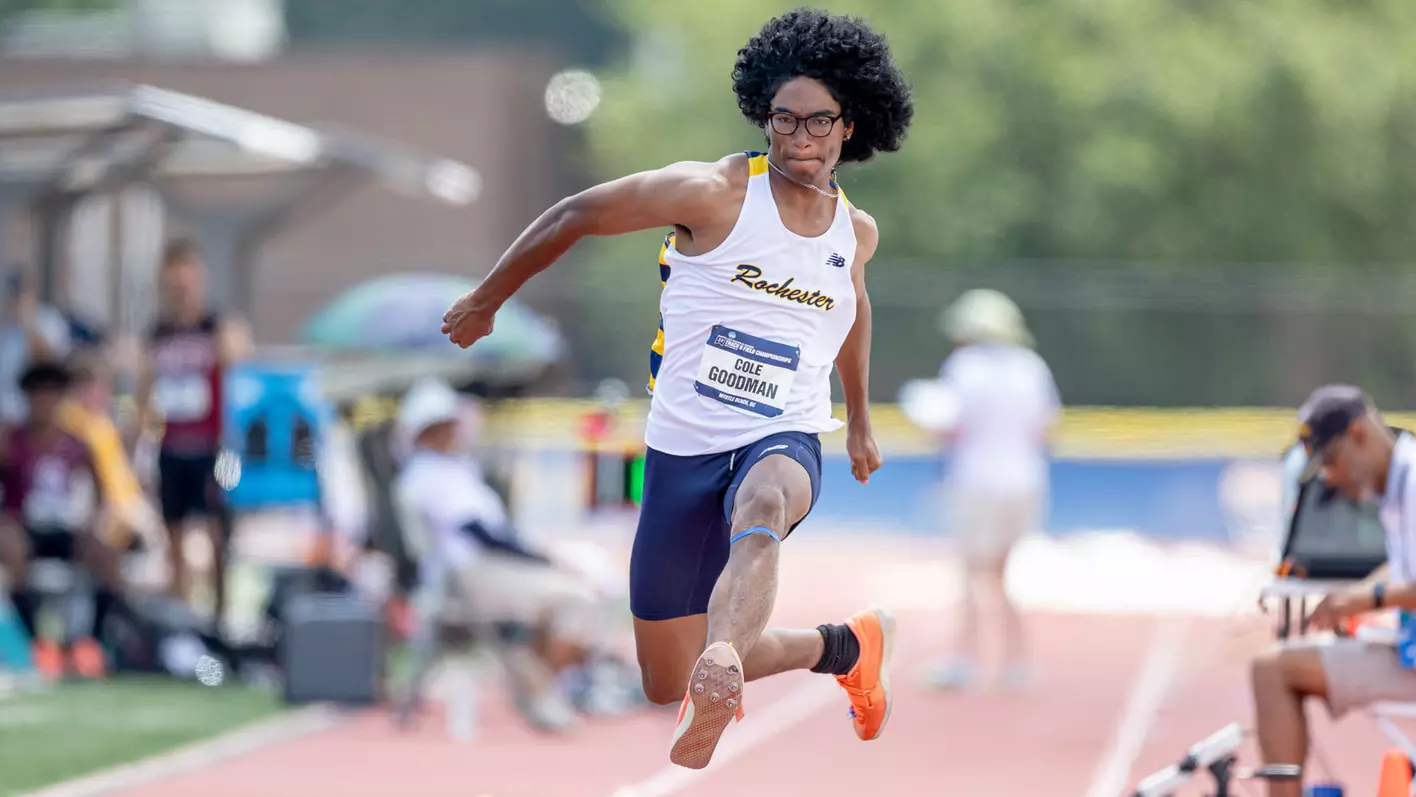 student on track mid jump