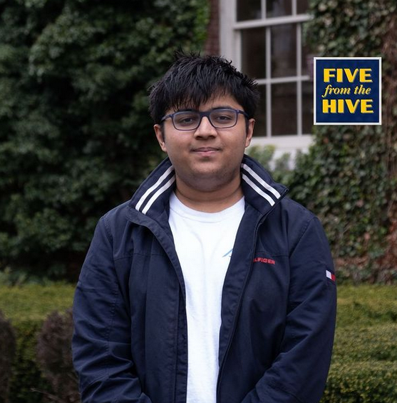 headshot of student outside in front of window and bushes