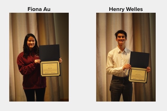 2 students posing holding certificates